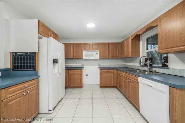 kitchen with light tile patterned floors, white appliances, and sink