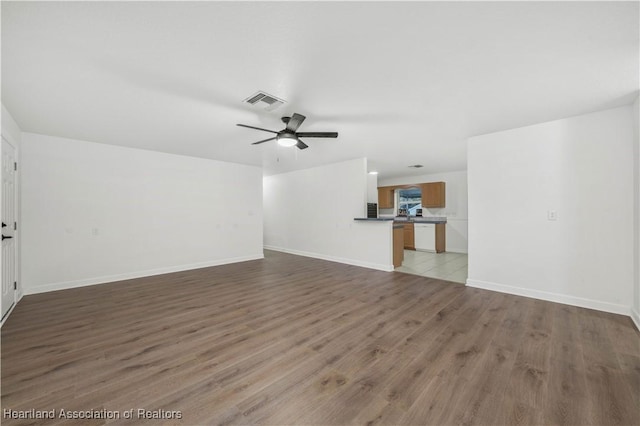 unfurnished living room featuring light wood-type flooring and ceiling fan