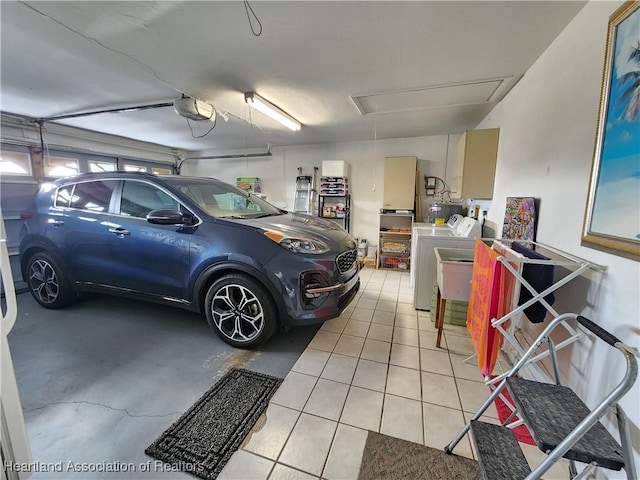 garage featuring washer and clothes dryer and a garage door opener