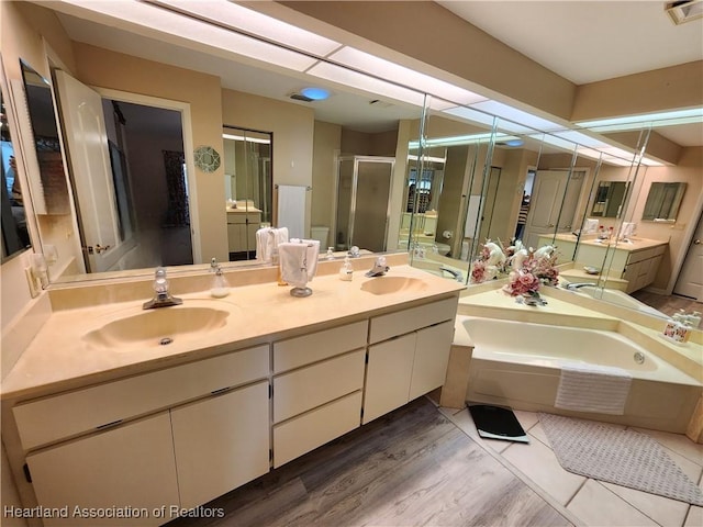 bathroom with vanity, plus walk in shower, and hardwood / wood-style flooring