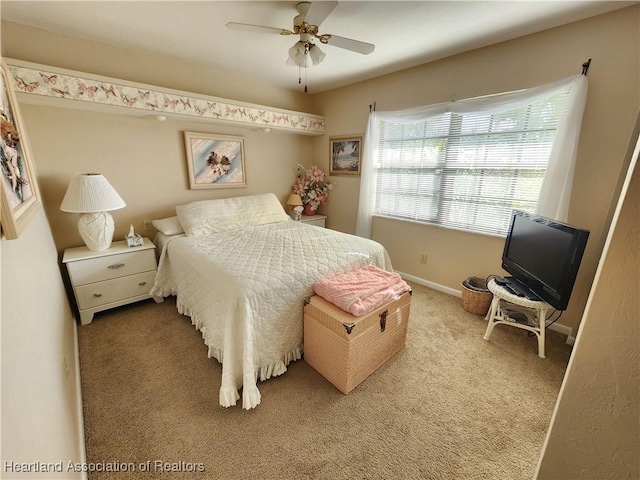 bedroom featuring ceiling fan and light carpet