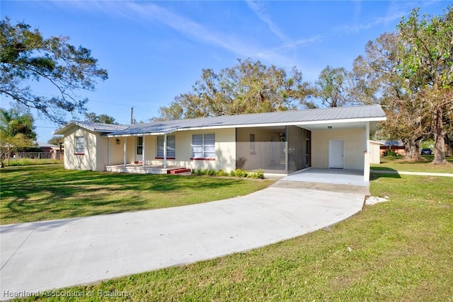 ranch-style home featuring a front yard and a carport