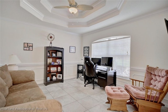 office area featuring light tile patterned floors, a tray ceiling, ceiling fan, and ornamental molding