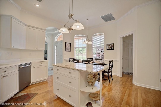 kitchen featuring dishwasher, pendant lighting, a center island, and white cabinetry