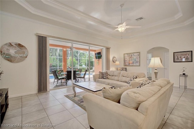 living room featuring light tile patterned floors, a raised ceiling, and ceiling fan