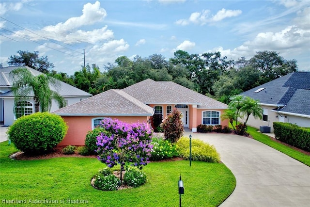 single story home featuring central air condition unit and a front yard