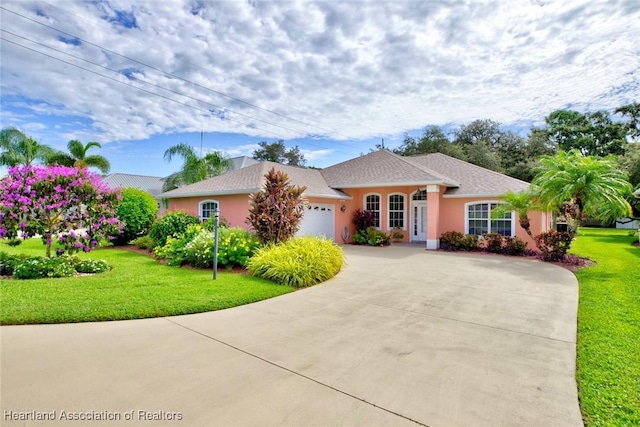 single story home with a front yard and a garage