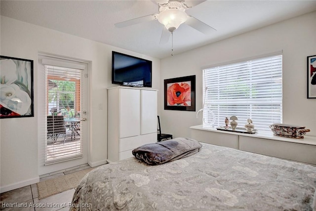 tiled bedroom featuring access to outside and ceiling fan