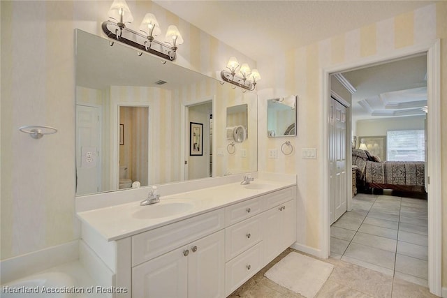 bathroom with tile patterned flooring, vanity, and toilet