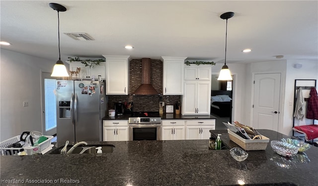 kitchen with visible vents, oven, white cabinets, stainless steel refrigerator with ice dispenser, and wall chimney exhaust hood