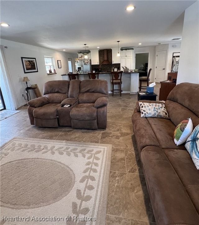 living area featuring recessed lighting and stone finish flooring