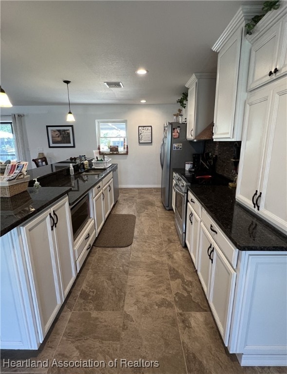 kitchen with electric range, backsplash, and white cabinets