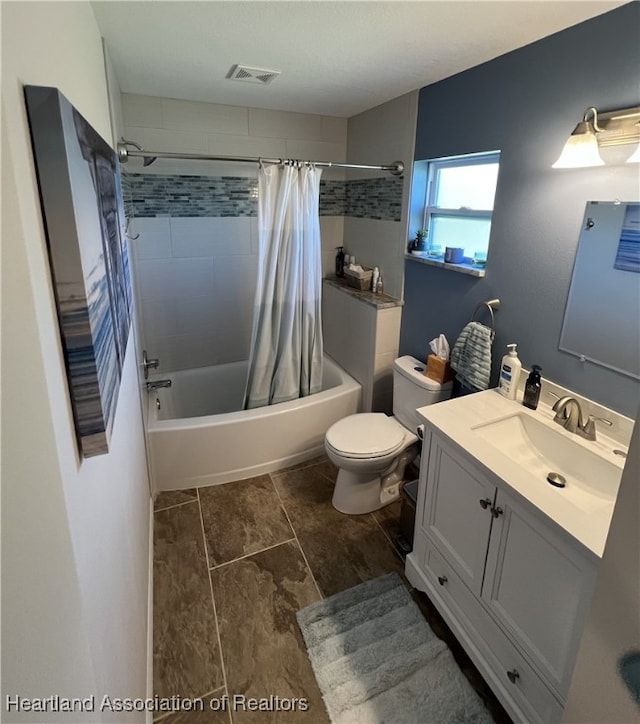 full bath with visible vents, toilet, shower / bath combo, and vanity