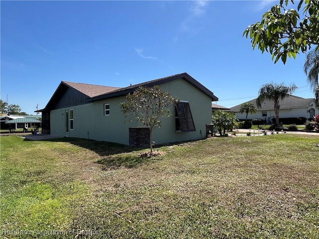 view of side of home featuring a lawn