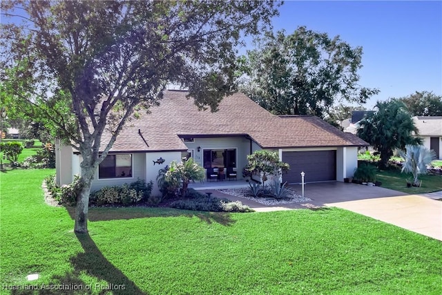 ranch-style home featuring a garage, stucco siding, concrete driveway, and a front lawn