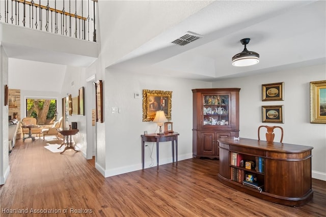 interior space featuring baseboards, visible vents, and wood finished floors