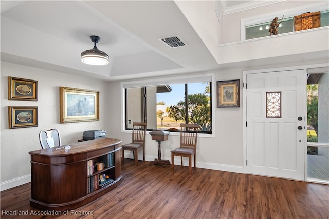 foyer entrance with baseboards, visible vents, plenty of natural light, and wood finished floors