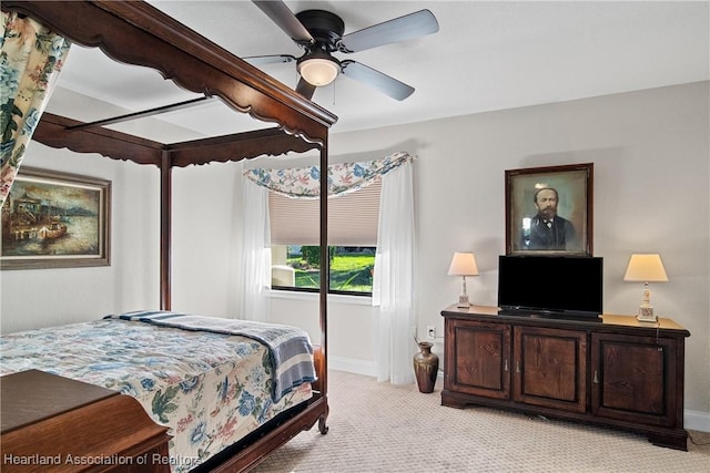bedroom featuring a ceiling fan, baseboards, and light carpet