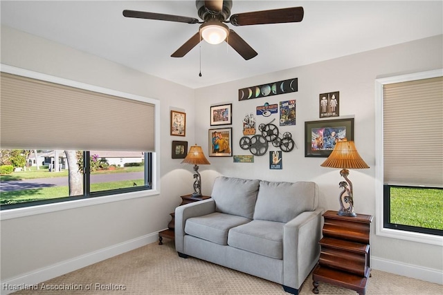 sitting room featuring baseboards, carpet, and a ceiling fan