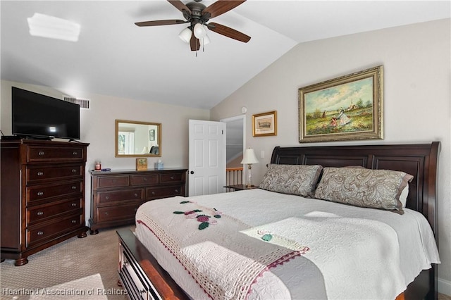 bedroom featuring a ceiling fan, visible vents, light carpet, and vaulted ceiling