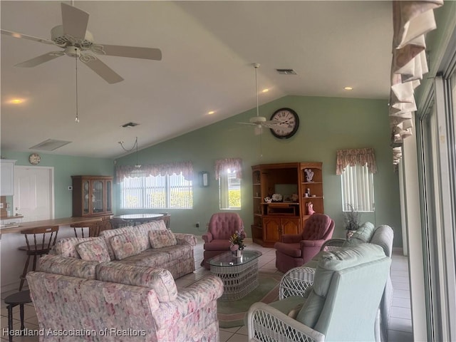 tiled living room featuring vaulted ceiling, a ceiling fan, and visible vents