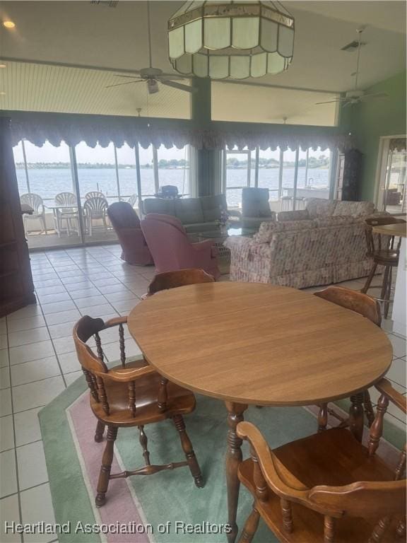 tiled dining room with a wealth of natural light and ceiling fan