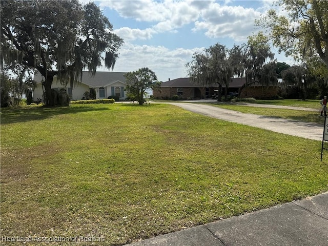 view of front of property with concrete driveway and a front yard