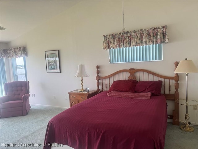 bedroom featuring vaulted ceiling, carpet flooring, and baseboards