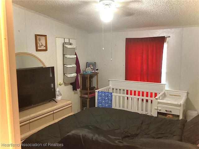 bedroom with lofted ceiling, ceiling fan, and a textured ceiling