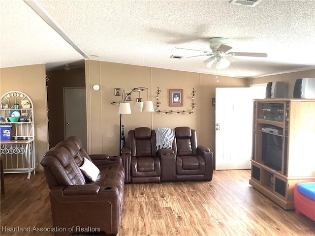 living room featuring a textured ceiling, hardwood / wood-style flooring, and ceiling fan