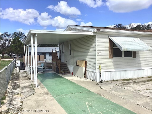 rear view of house featuring a carport