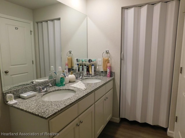 bathroom featuring vanity and hardwood / wood-style floors