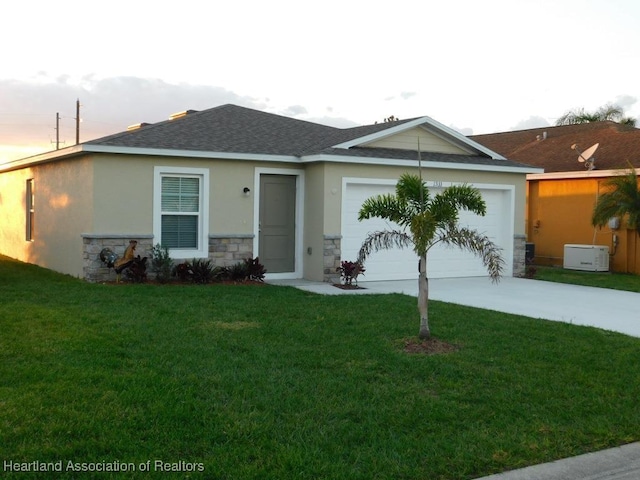 ranch-style home featuring a garage and a front lawn