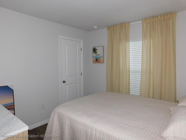 bedroom with wood-type flooring