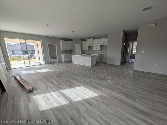 unfurnished living room with light hardwood / wood-style flooring