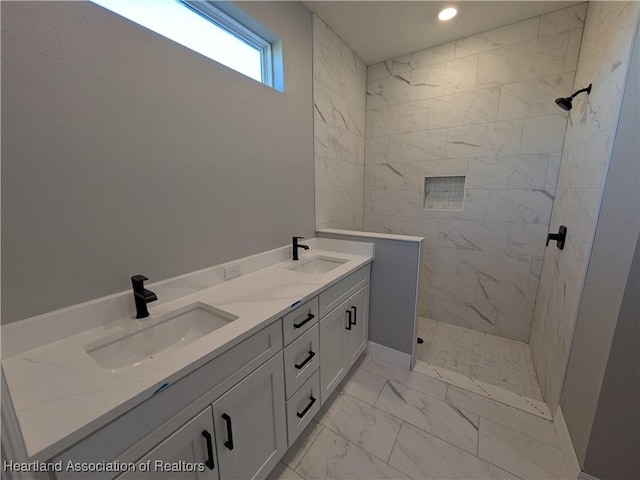 bathroom featuring vanity and a tile shower