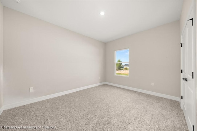4924 San Lorenzo Dr, Sebring, FL 33872 - spare room with baseboards, carpet, and recessed lighting