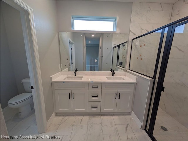 bathroom featuring toilet, vanity, and a shower with shower door