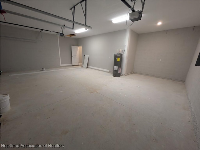 garage featuring water heater and a garage door opener