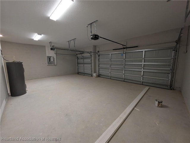 garage with a garage door opener, water heater, and electric panel