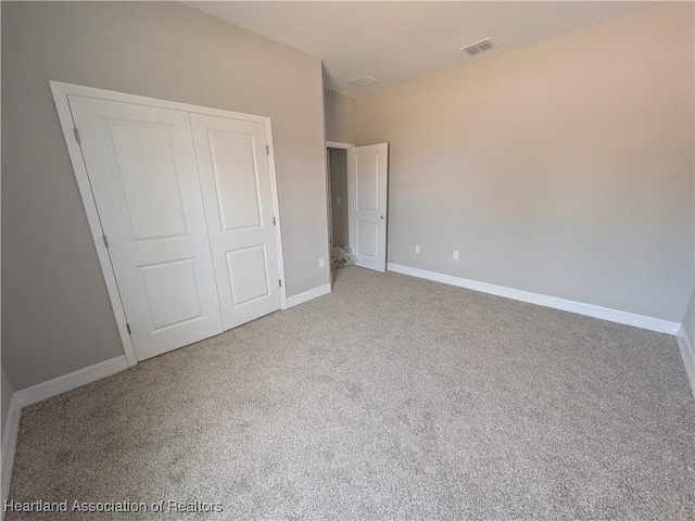 unfurnished bedroom featuring carpet floors and a closet