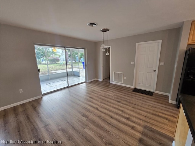 unfurnished dining area featuring dark hardwood / wood-style floors