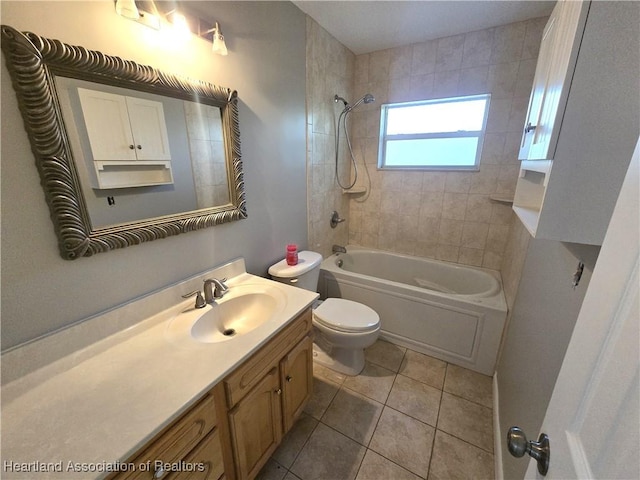 full bathroom with tile patterned flooring, vanity, tiled shower / bath combo, and toilet