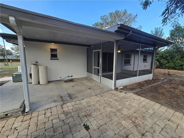 back of house featuring a sunroom and a patio area