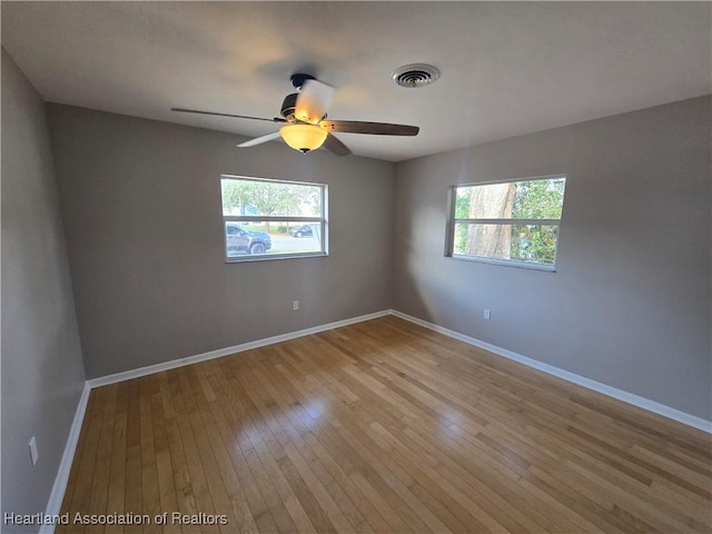 spare room with ceiling fan and light hardwood / wood-style floors