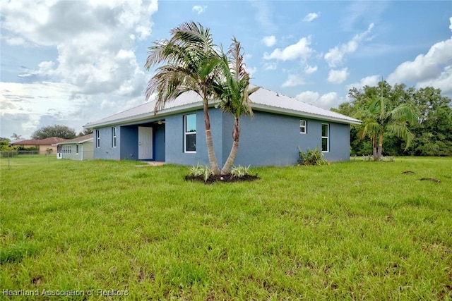 rear view of property with a yard