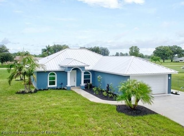 single story home featuring a garage and a front lawn