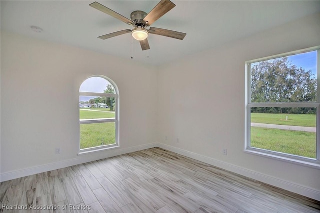 empty room featuring ceiling fan and light wood-type flooring