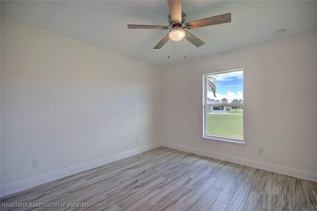 spare room featuring ceiling fan and light wood-type flooring