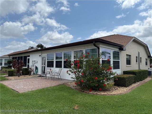 3711 Perugia Ave, Sebring, FL 33872 - rear view of property with a patio area, a yard, and central AC